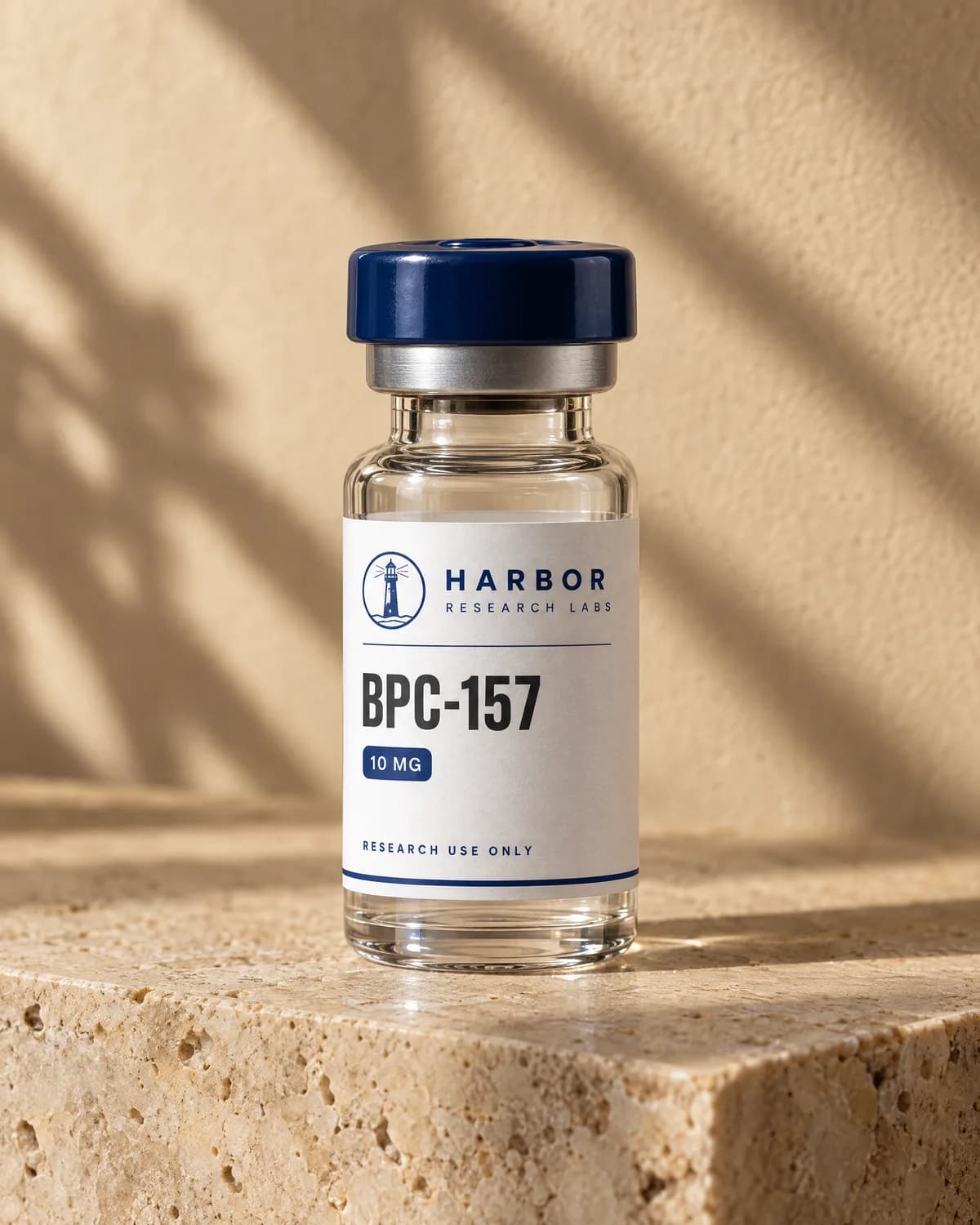 After: the same vial with a navy cap and a printed Harbor Research Labs label, rendered on travertine in warm light.